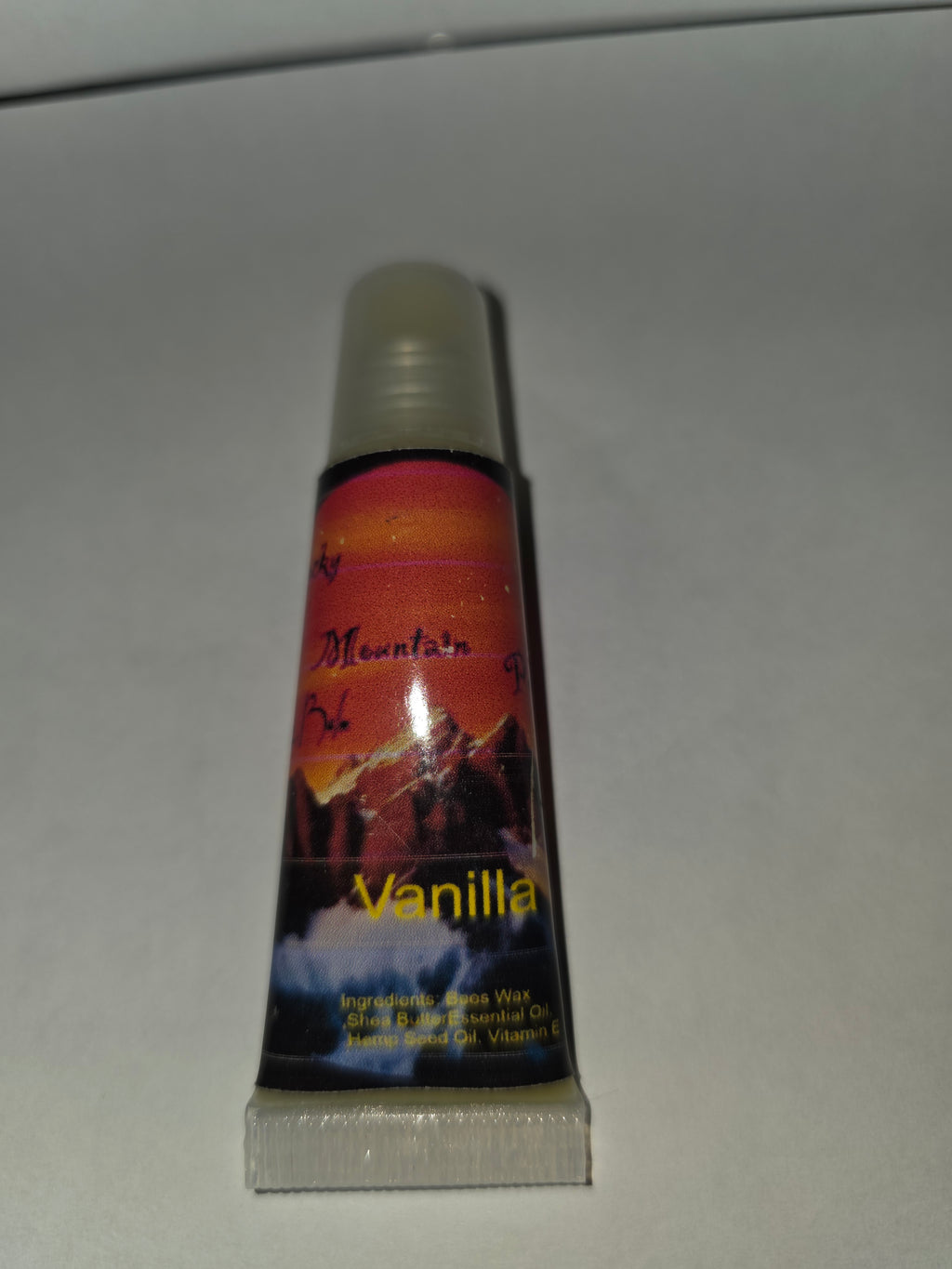 Vanilla lip balm squeeze tube with cap on and label facing forward