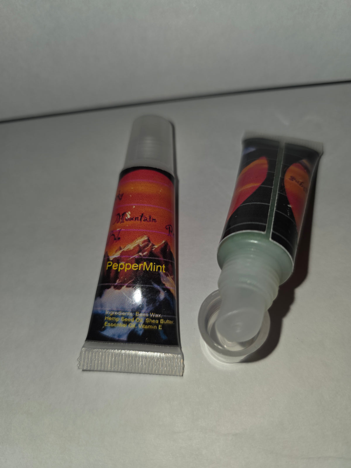 Peppermint Lip Balm squeeze tubes showing the applicator with cap removed
