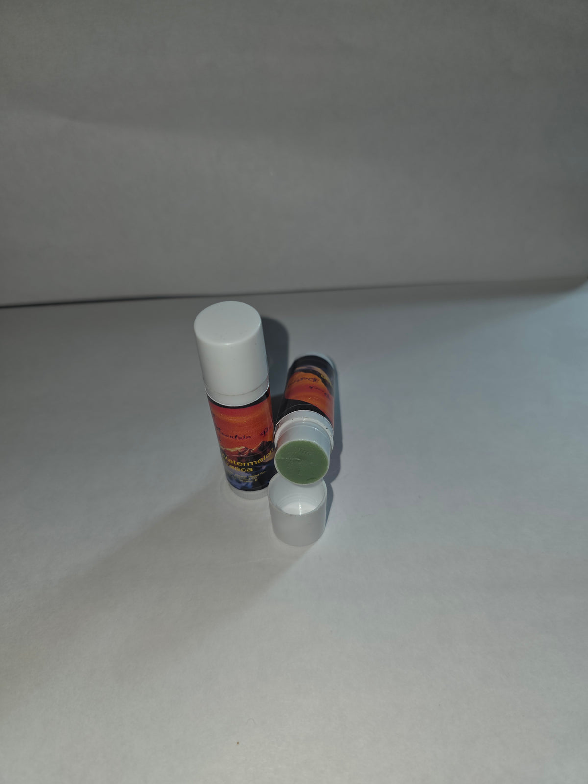 Watermelon Fresca Lip Balm twist tubes showing closed packaging and exposed balm