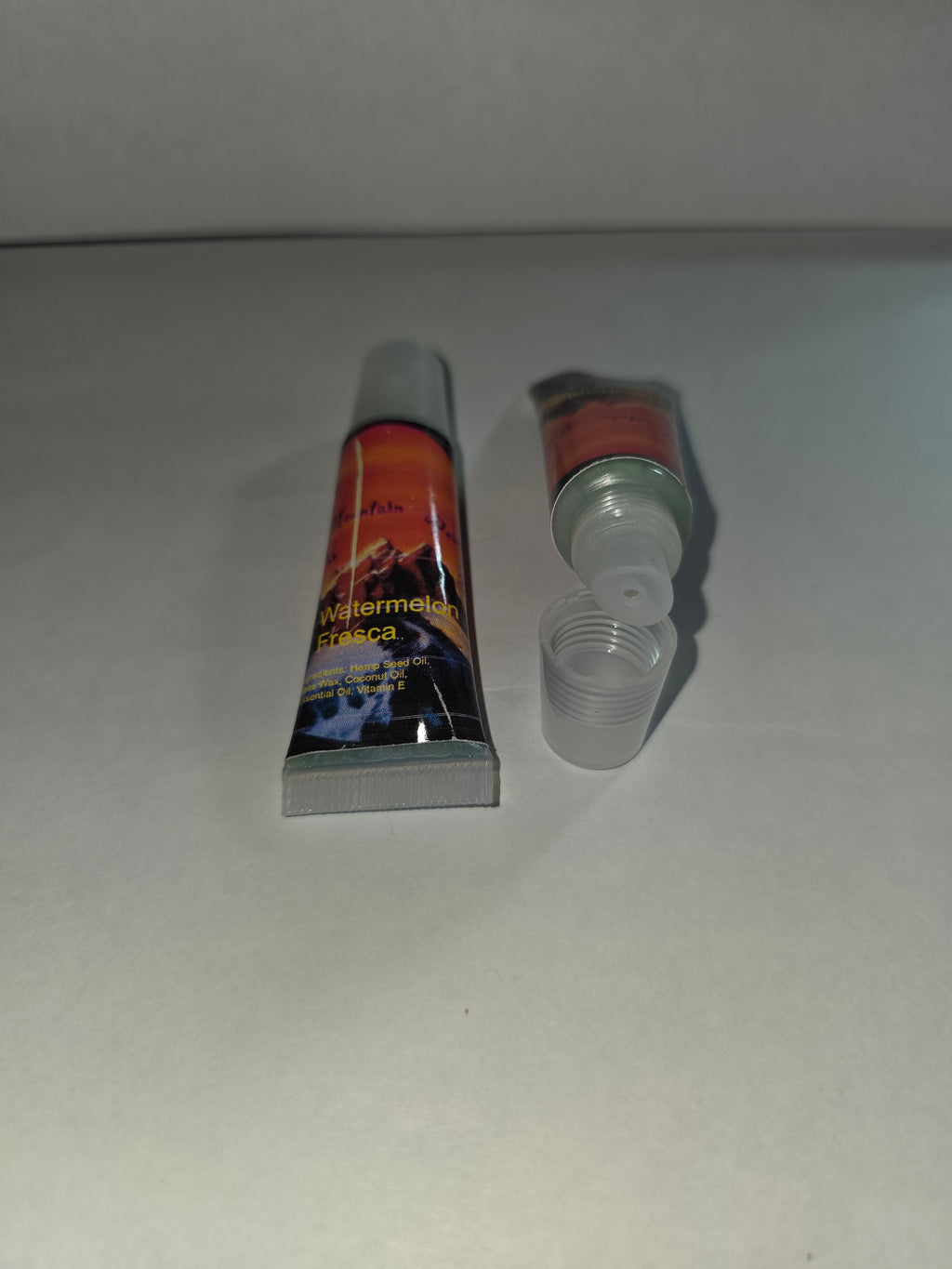 Watermelon Fresca Lip Balm squeeze tubes showing closed packaging and open applicator