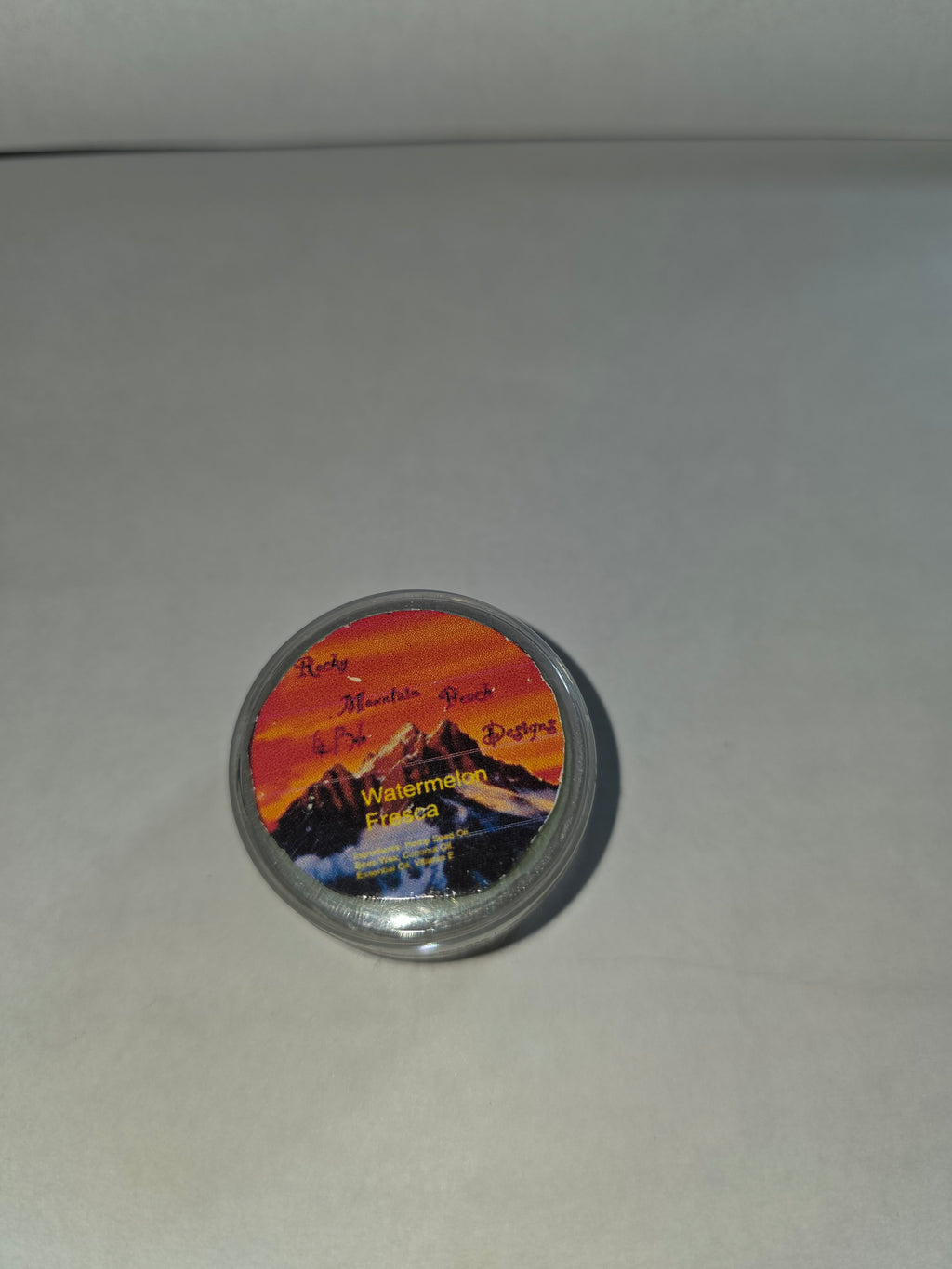 Closed Watermelon Fresca Lip Balm canister with labeled lid