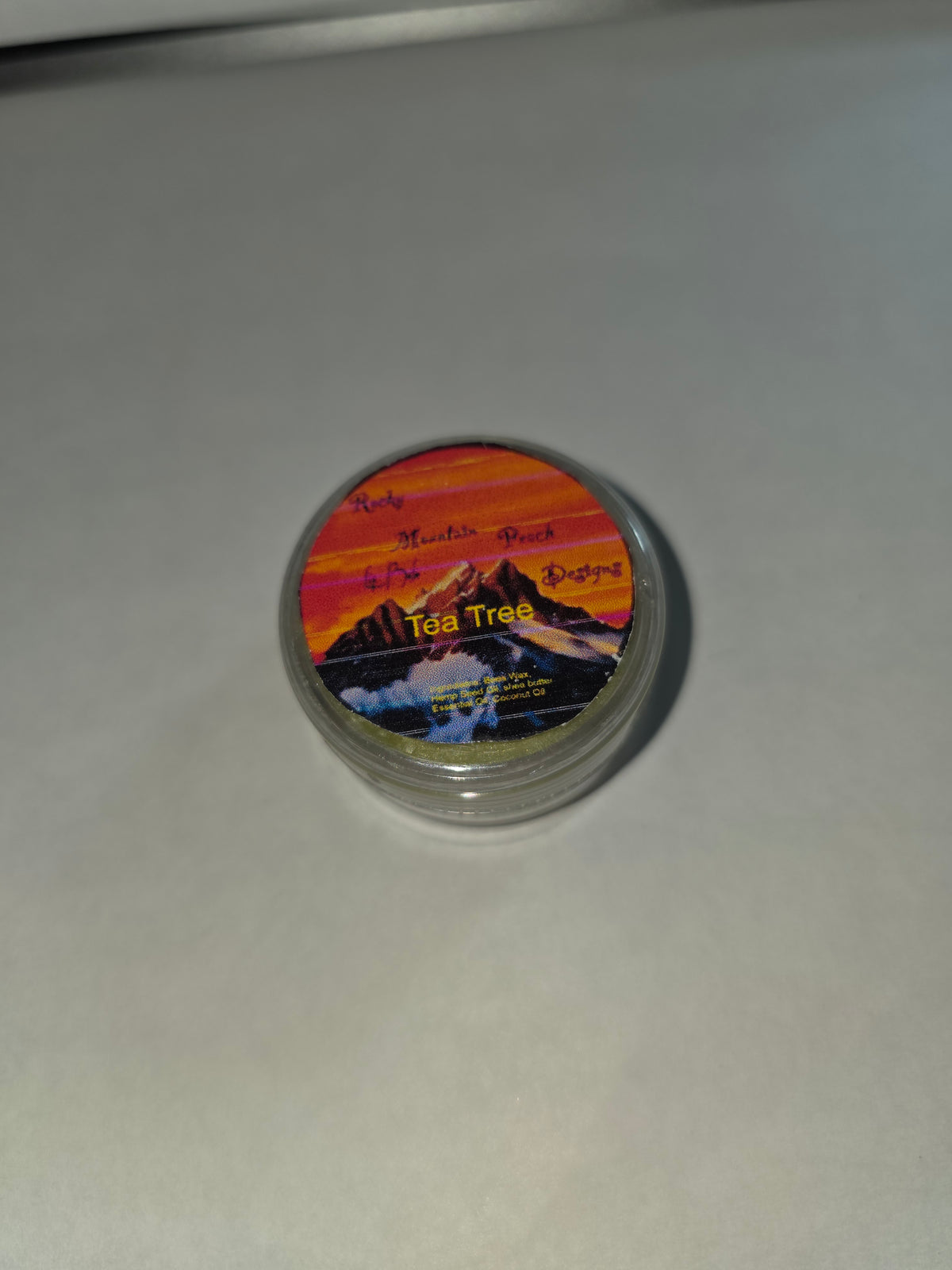 Closed Tea Tree Lip Balm canister with labeled lid