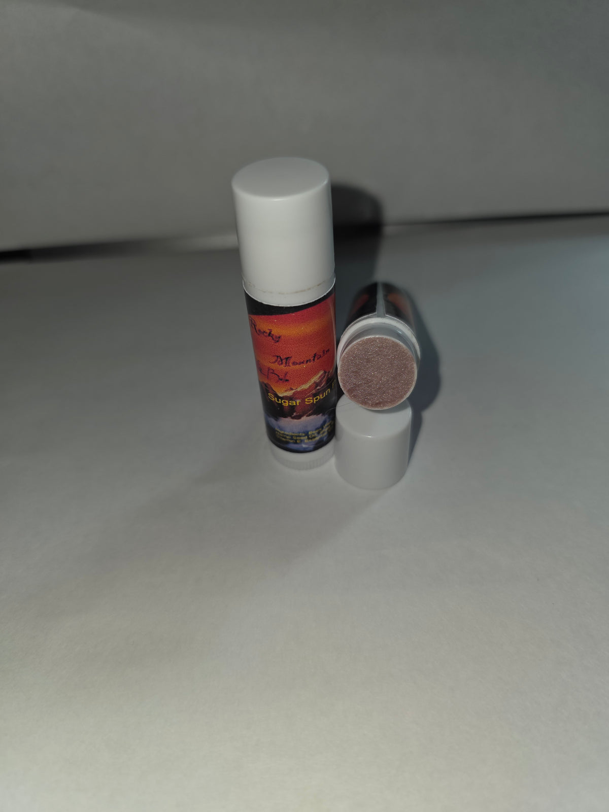 Sugar Spun Pineapple Lip Balm twist tubes showing closed and open packaging