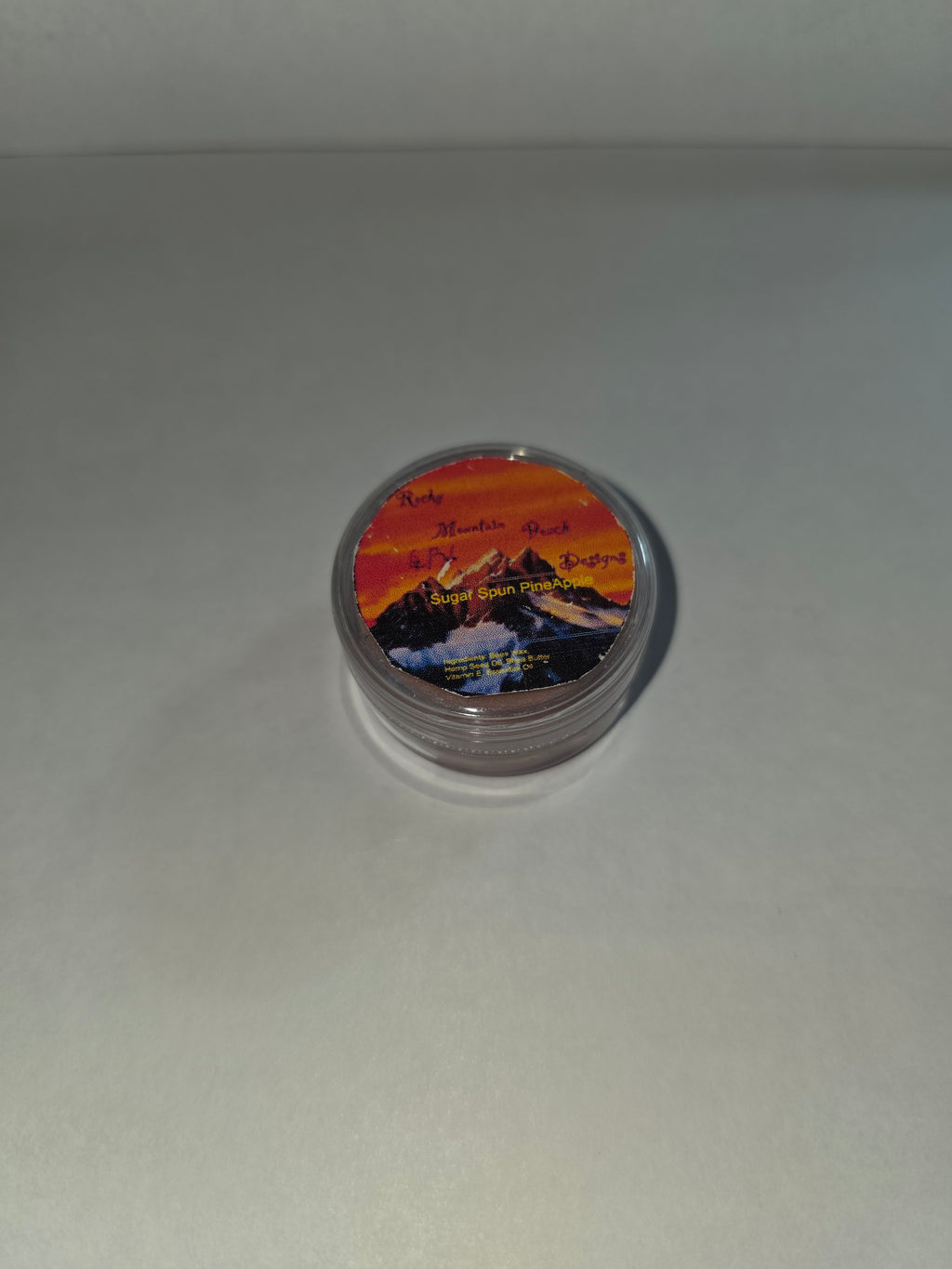Closed Sugar Spun Pineapple Lip Balm canister with labeled lid