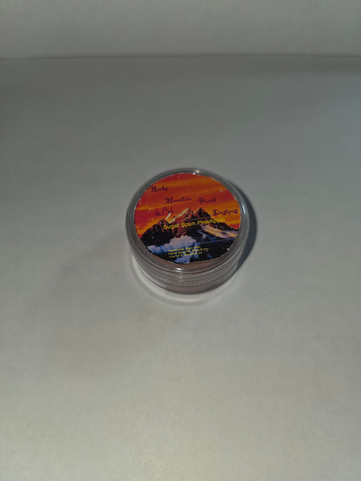 Closed Sugar Spun Pineapple Lip Balm canister with labeled lid