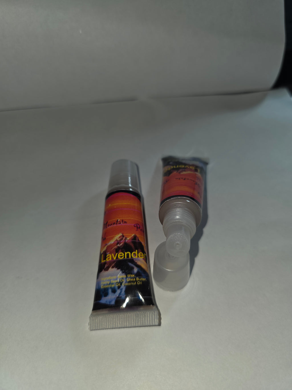Lavender Lip Balm squeeze tubes showing capped and open packaging