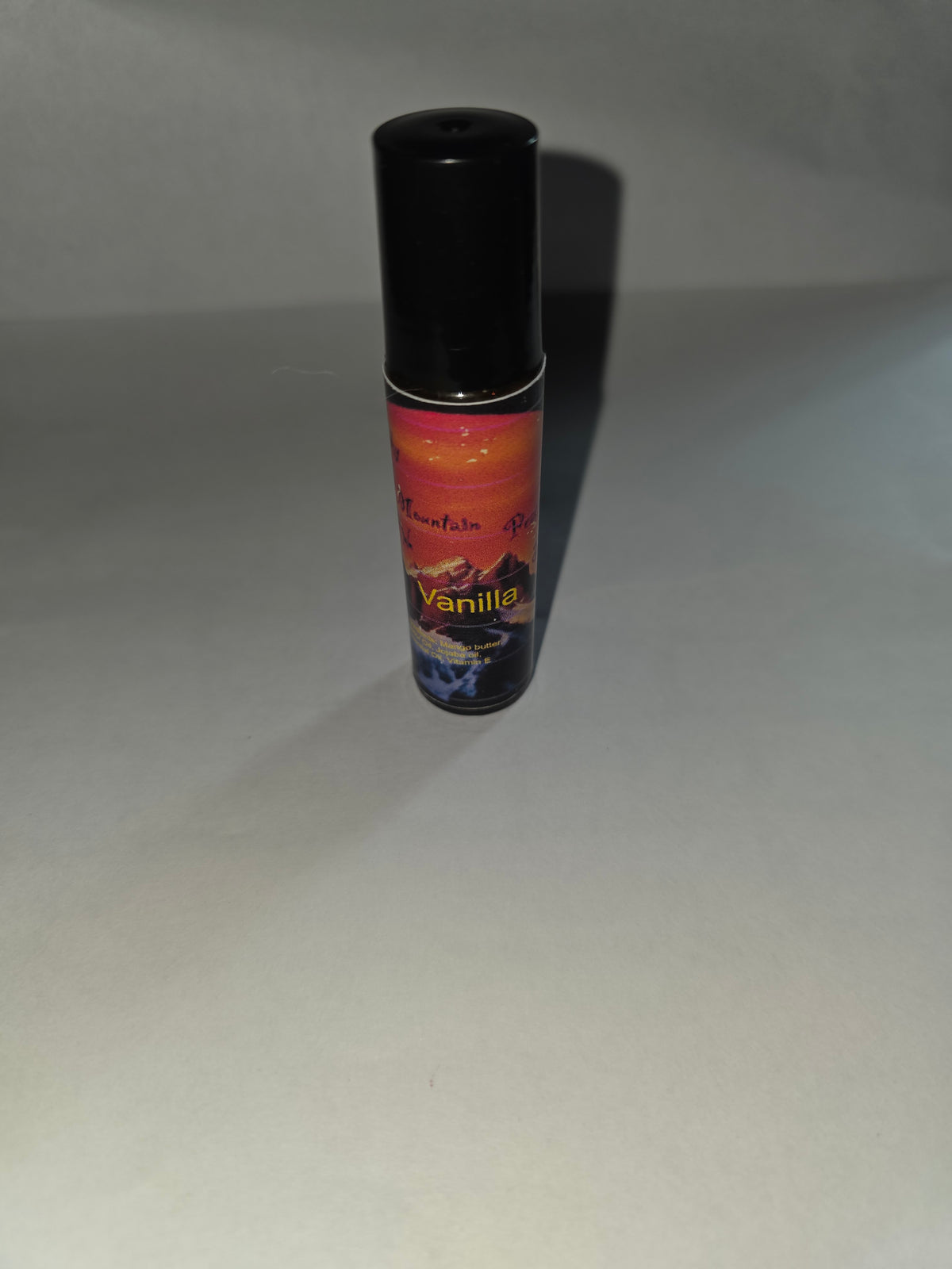 Vanilla Lip Gloss with black cap on